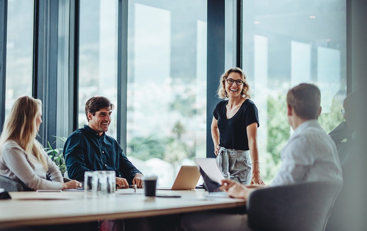 Business people having casual discussion during meeting happy team members